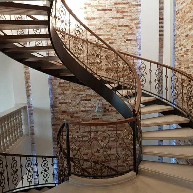 یک پله گرد سنگی همراه با نرده های فلزی آغشته شده به رنگ